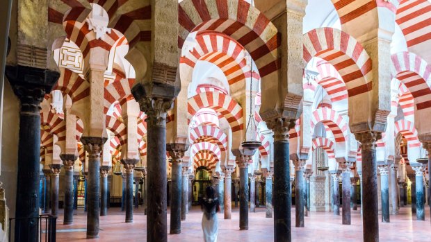 Woman walking inside the Mezquita of Cordoba.