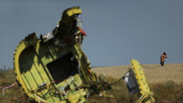 Wreckage from Malaysia Airlines flight MH17 lies in a field in eastern Ukraine. Despite the two incidents involving the airline, overall there were fewer air accidents in 2014.
