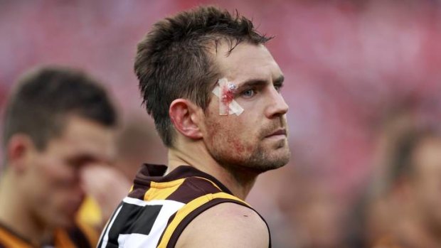 Warrior of the game: A bloodied and bruised Luke Hodge ponders what might have been.