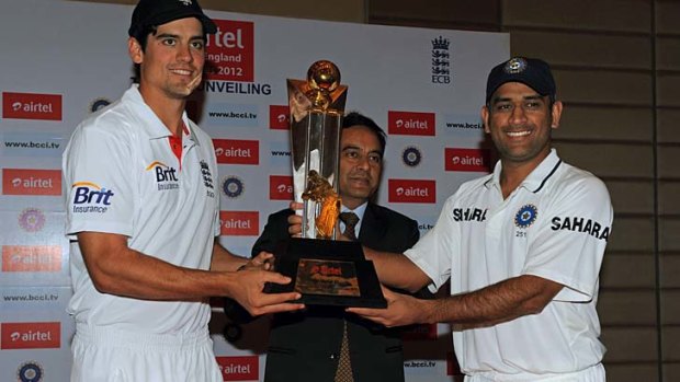 England captain Alastair Cook and his Indian counterpart, Mahendra Singh Dhoni, pose with the trophy which will be awarded to the winner of the Test series that begins on Thursday.