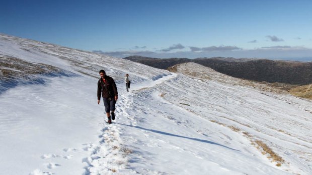A pair of French backpackers make their way through the snow near the Little Austria section of the main range trail, as they make their way towards Mount Kosciuszko.