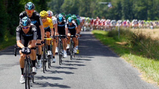 Austrian Bernhard Eisel (front) drives the peloton, defending the yellow jersey of the race leader and their teammate, British rider Bradley Wiggins, during stage 10.