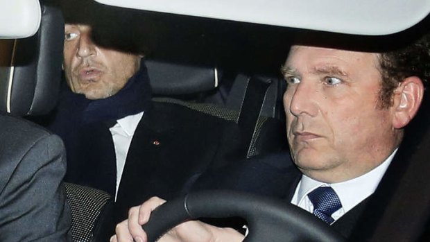 Former French president Nicolas Sarkozy, left, leaves the courthouse in Bordeaux.