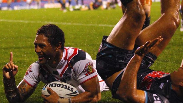 At the double &#8230; Manu Vatuvei slides over to score one of his two tries at a rain-soaked Centrebet Stadium last night despite the attentions of Penrith winger Etu Uaisele.
