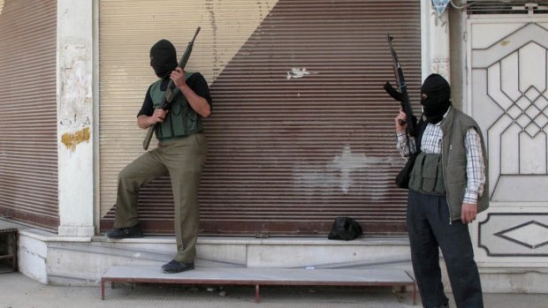 Free Syrian Army fighters stand guard during fighting with Syrian troops.