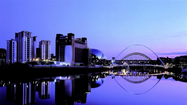Newcastle by night: The redeveloped Tyne River waterfront and Gateshead Millennium Bridge.