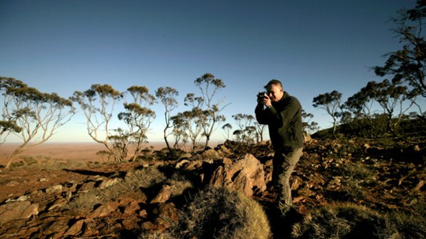 Unique...Dr John Benson photographs the spinifex and porcupine grass on Mundi Mundi mountain near Broken Hill.