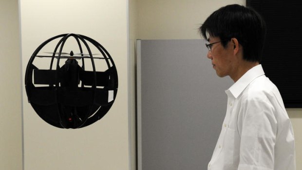 Advanced Defence Technology Centre Engineer Fumiyuki Sato displays his spherical observation drone.