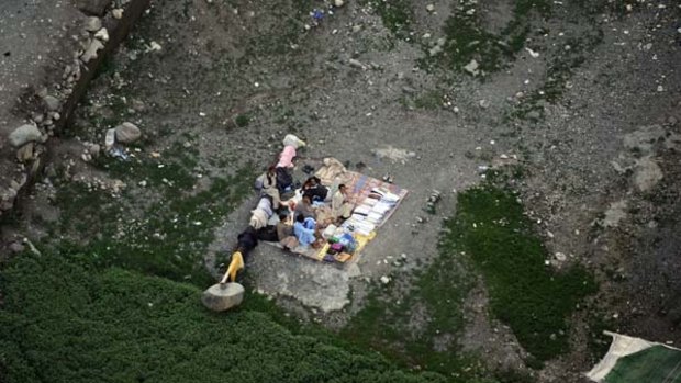 Pakistani flood survivors rest in an open area at the Kallam valley.