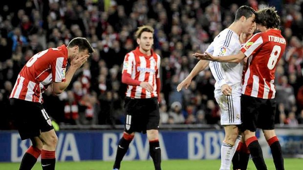 Red mist: Real Madrid's Cristiano Ronaldo gets in the face of Athletic Bilbao's Ander Iturraspe after slapping Carlos Gurpegi.