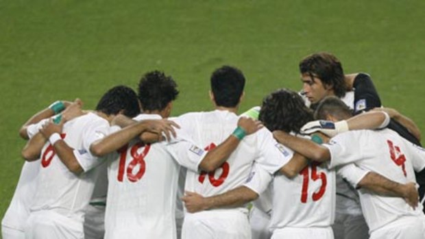 Solidarity...Iranian soccer players wear green arm bands.