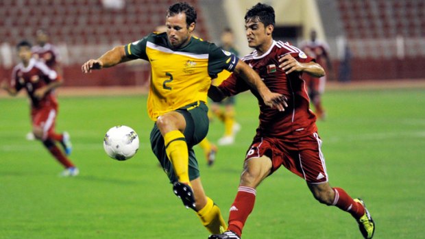 Muscat flashback...  Lucas Neill fends off Oman's Abdulaziz Almkabbala during the World Cup qualifier in November.
