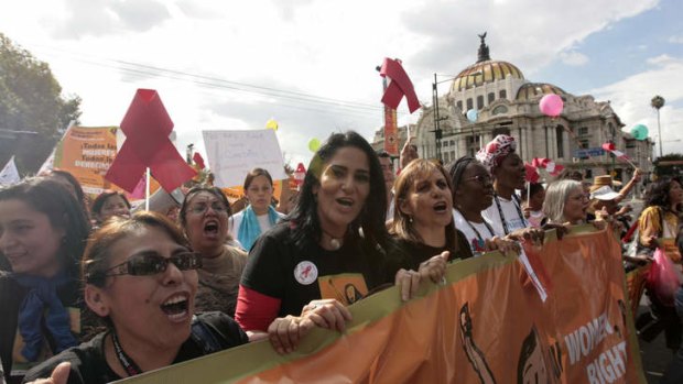 On the march: Lydia Cacho (front, second from left) holds a banner with other female activists during a demonstration in Mexico City in 2008.