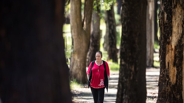 Lesley Bebbington walks among the trees around Kinglake. 