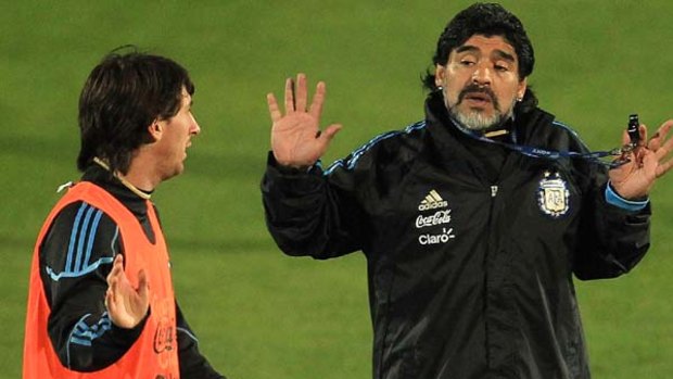 Madcap ... Diego Maradona, right, chats to Lionel Messi during the training session.