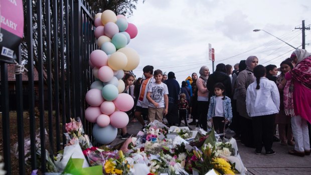 People gather for a vigil at Banksia Road Public School in Greenacre where two children where killed on Tuesday after a car unintentionally ploughed into a classroom.