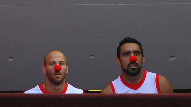 Swans Jarrad McVeigh and Adam Goodes wear red noses during a break in practice yesterday.
