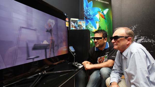 Harvey Norman CEO Gerry Harvey samples 3D TV in his Chatswood store.