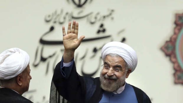 Iran's new President Hasan Rouhani waves after his swearing in at the parliament in Tehran.