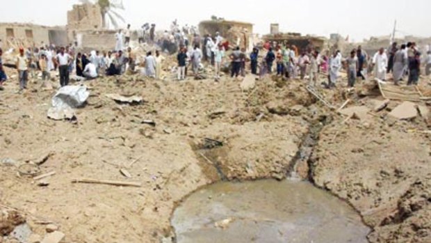 Iraqis gather around a crater caused by a truck bomb in the northern city of Kirkuk.
