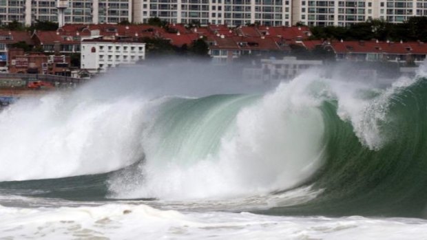 A dangerous wave crashes over Haeundae Beach in Busan, South Korea, as Typhoon Neoguri approaches the Korean Peninsula.