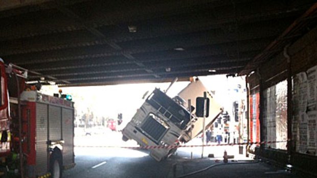 A truck wedged under the rail bridge at the intersection of Flinders and Spencer streets earlier this afternoon.