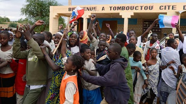 Joyous &#8230; residents welcome French and Malian troops after they entered Timbuktu, which had been occupied for 10 months by radical Islamists.