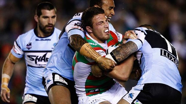 Surrounded by Sharks ... Sam Burgess is halted by the Cronulla defence.
