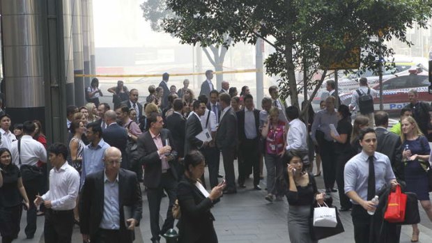 Office workers evacuate while a fire burns at Barangaroo.