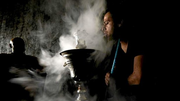 Saddique Baig smoking a Shisha pipe at the Arabesque Shisha lounge in Coburg.