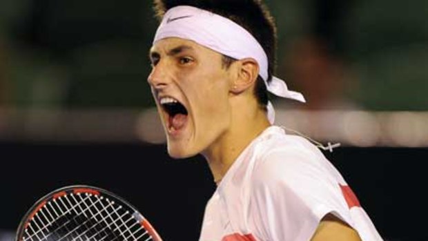 Bernard Tomic celebrates after winning the third set against Marin Cilic last night.