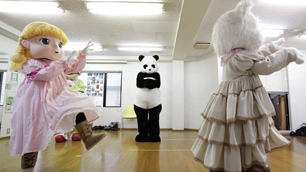 Watch and learn ... trainees in character mascots costumes practice their movements at the Choko Group mascot school in Tokyo.