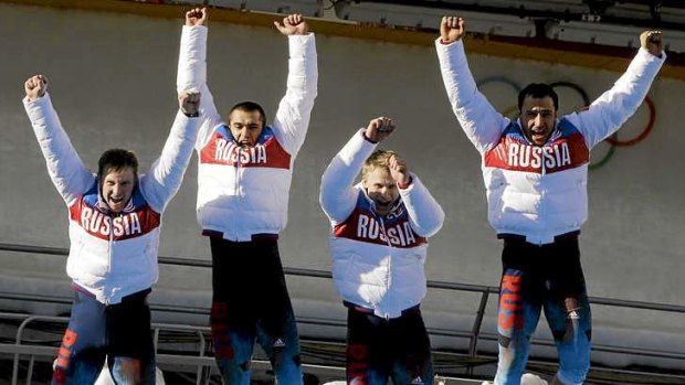 What a feeling: The gold medal team from Russia, with Alexander Zubkov, Alexey Negodaylo, Dmitry Trunenkov, and Alexey Voevoda, jump onto for joy on the dais.