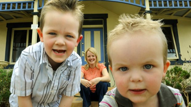 Jocelyn Bennett, with Xavier, 4, and Eliott, 2, at home in Caroline Springs, enjoys her lifestyle, but according to a report, many in planned communities face financial challenges.