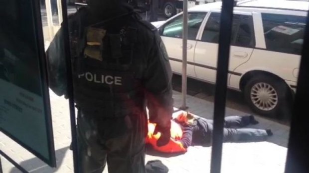 A still from iPhone footage taken by an onlooker shows one of the men arrested at Cabramatta on Monday.