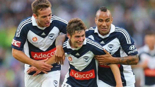 Party time: Matthew Foschini and Archie Thompson get around goalscorer Marco Rojas on Friday night. Victory won an entertaining match 3-2 against Newcastle.
