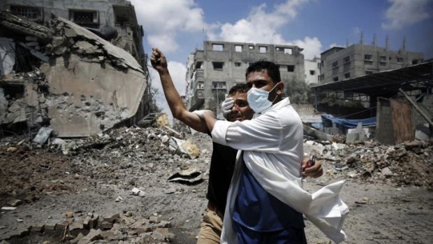 A medic helps a Palestinian in the Shujaiya neighbourhood of Gaza City, heavily shelled during the latest Israeli offensive.