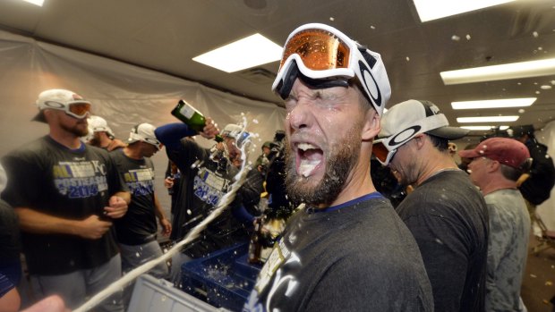 Spray time: Royals players celebrate the win that ended their playoff drought.