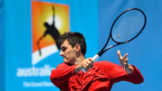 All about practice &#8230; Bernard Tomic goes through his paces at Melbourne Park before his first-round match.