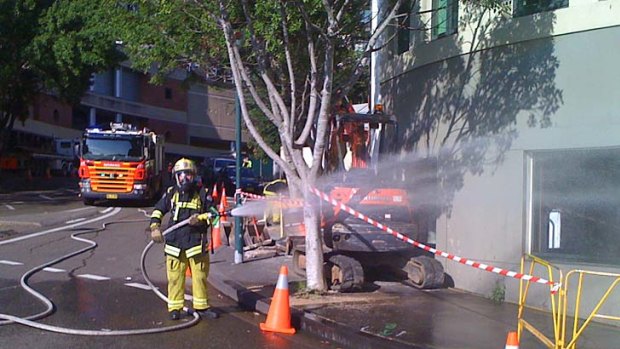 Gas leak ... fire crews hose down walls on on the corner of Jones Bay, Pirrama and Darling Island roads today.