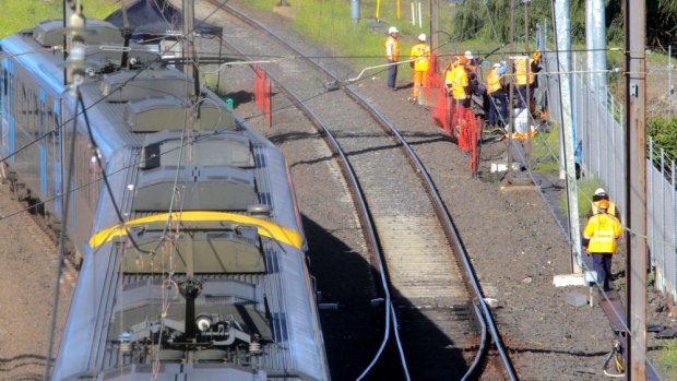 Workers inspect fire-damaged cables near Richmond station.