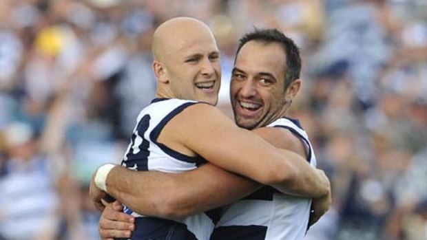 Gary Ablett celebrates a goal with new Cat cult figure James Podsiadly.