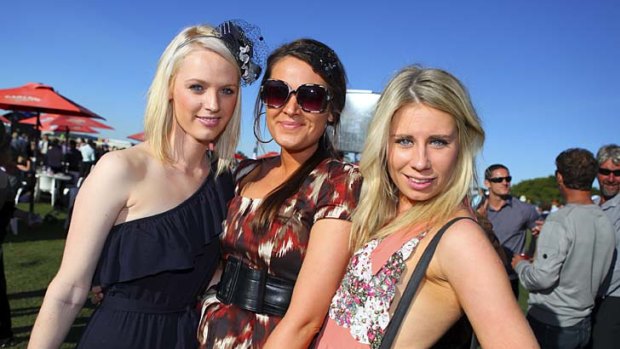 Great fun ... Courtney Loudon, Suz Bish, and Emily Conlon at Doomben Racecourse for the BTC Cup yesterday.
