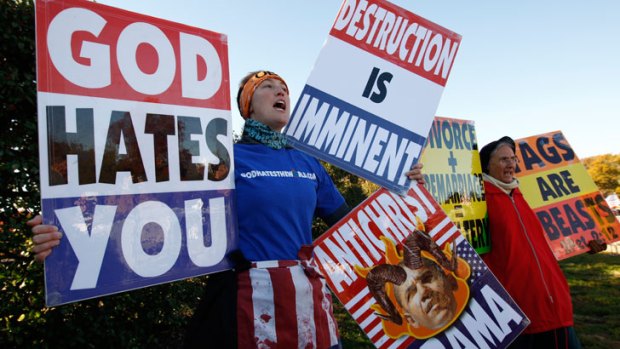 Members of the Westboro Baptist Church hold anti-gay signs at Arlington National Cemetery in the US on Veterans Day. They have recently turned their attention on Margaret River high school students.