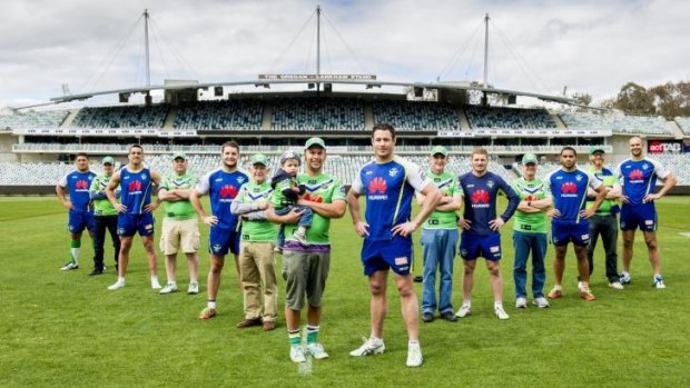 A select group of dedicated Canberra Raiders fans wearing Saturday’s game jerseys with their names embroidered on the chest, which will be worn by the players. Pictured from left are Josh Papalii, fan Tim Keed,  Paul Vaughan, fan Ralph Bradbury,  Jarrod Croker, fans Ron Bartier, Eli, 2, and father Mitchell Keegan, Brett White, fan Ron Kropp, Glen Buttriss, fan Jeff Boag,  Bill Tupou, fan Lachlan Cameron and Dane Tilse.