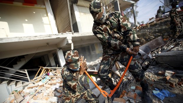 Nepalese soldiers search for earthquake victims on Wednesday. 
