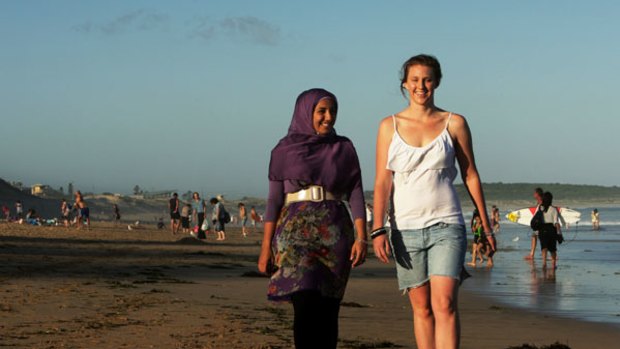 Side by side ...  Mecca Laalaa and Kim Short walk along Cronulla beach. They became friends while walking the Kokoda Track last year, an initiative organised in the wake of the Cronulla riots.