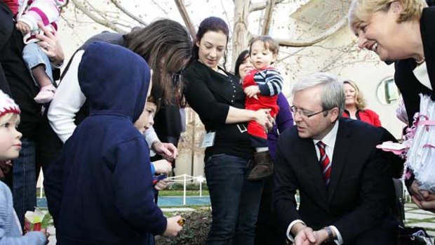 Ben Blair, 4, shows his Transformer to Kevin Rudd and Jenny Macklin at Parliament House, where mothers handed over a petition calling for a paid parental leave scheme.