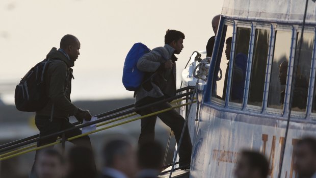 Migrants board a ferry at the port of Mytilene in Lesbos on Monday on the first day of the implementation of the deal between EU and Turkey.