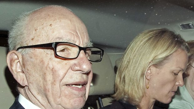 Investigation continues ...  Rupert Murdoch, with daughter Elisabeth, leaving his London apartment.